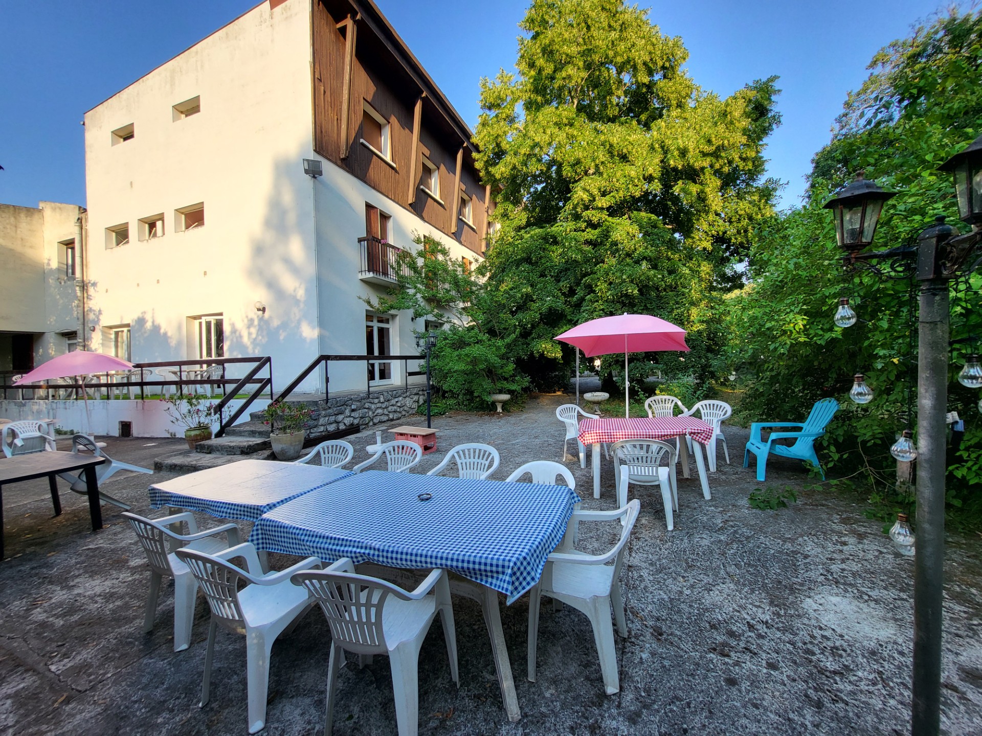 La terrasse de La Pierre-Lys sous les grands arbres